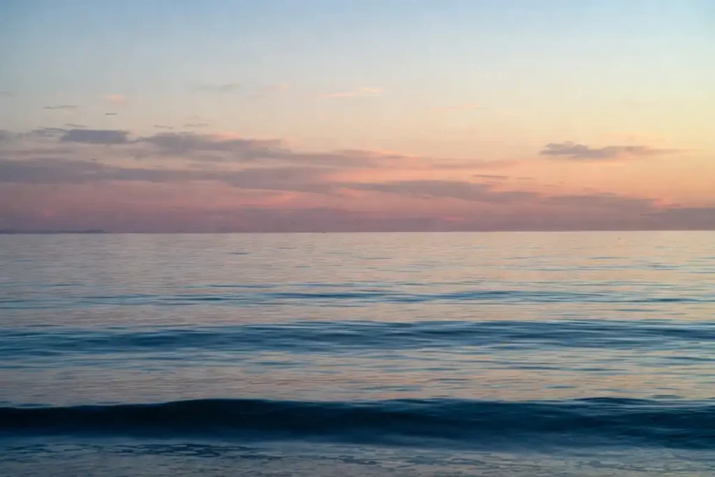 Peaceful ocean sunrise that reflects the calming mood of nature beauty quotes