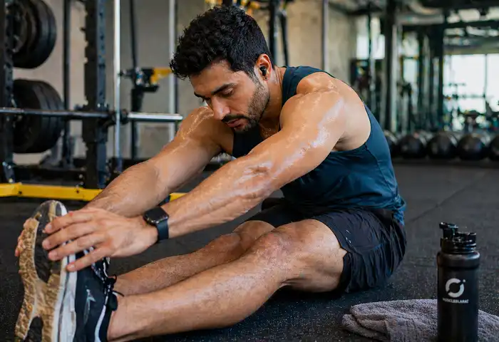 athlete stretching legs after workout muscle recovery