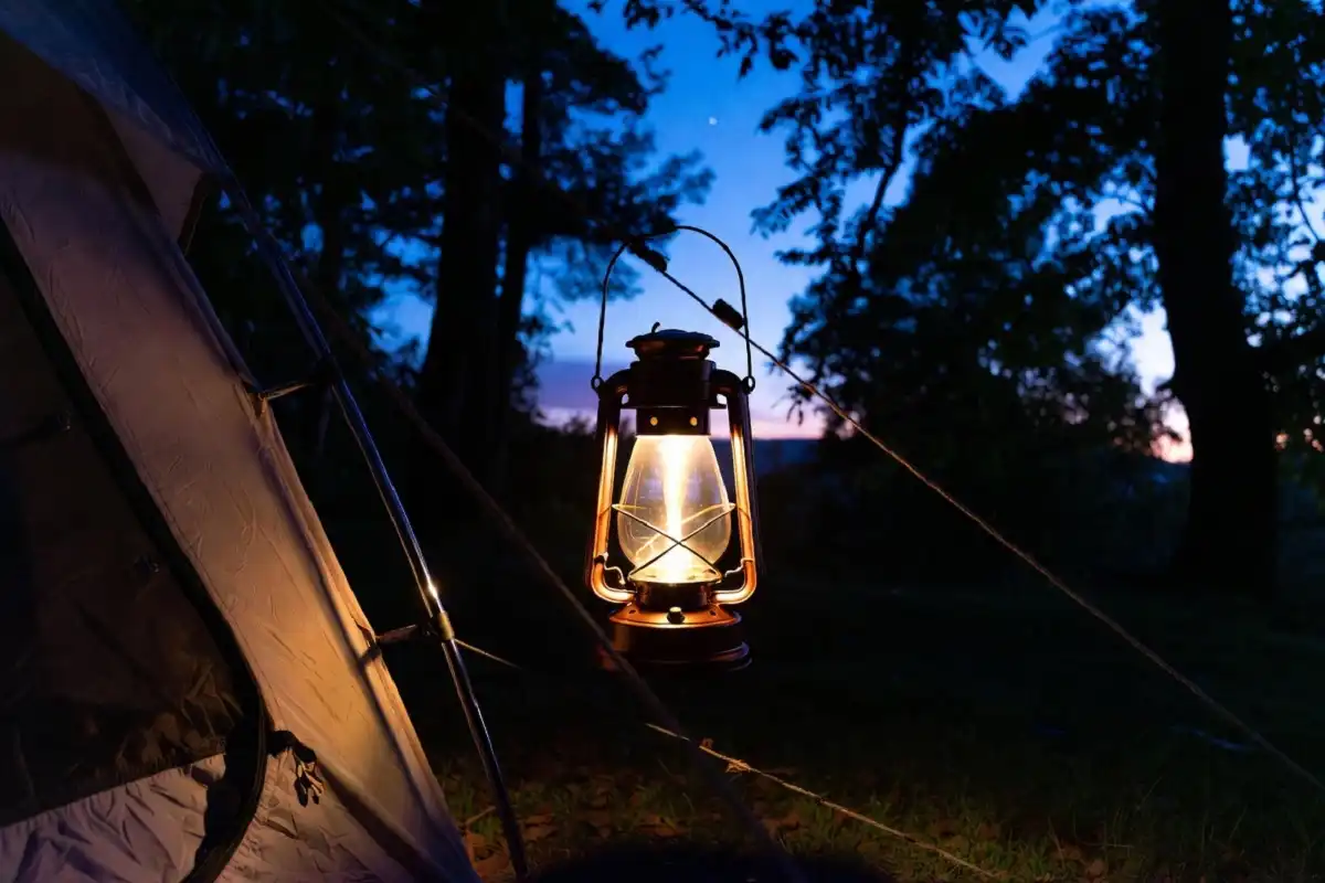 Eco-friendly camping lantern lighting up a campsite in the forest