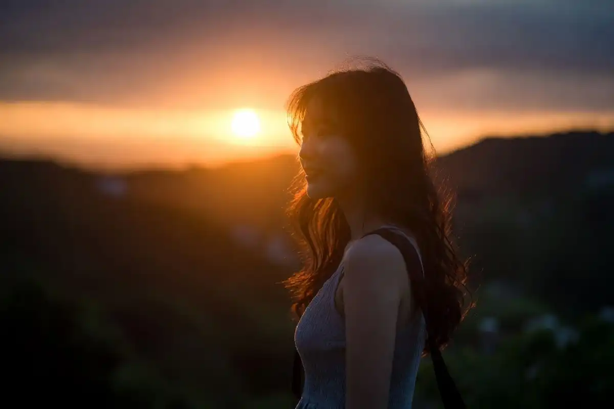 Person enjoying golden hour reflecting on the nature of daylight
