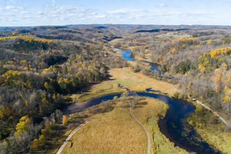 Aerial view of Indian Creek Nature Center trails and forests in Cedar Rapids Iowa during fall