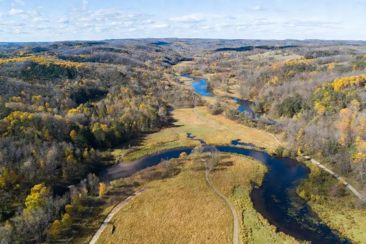 Aerial view of Indian Creek Nature Center trails and forests in Cedar Rapids Iowa during fall