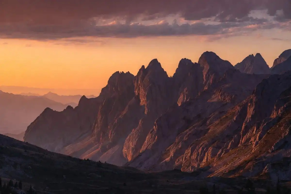 Mountain sunset nature background with orange sky and peaks