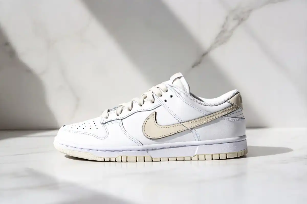 Nike Dunk Low Next Nature white sanddrift colorway on clean studio background