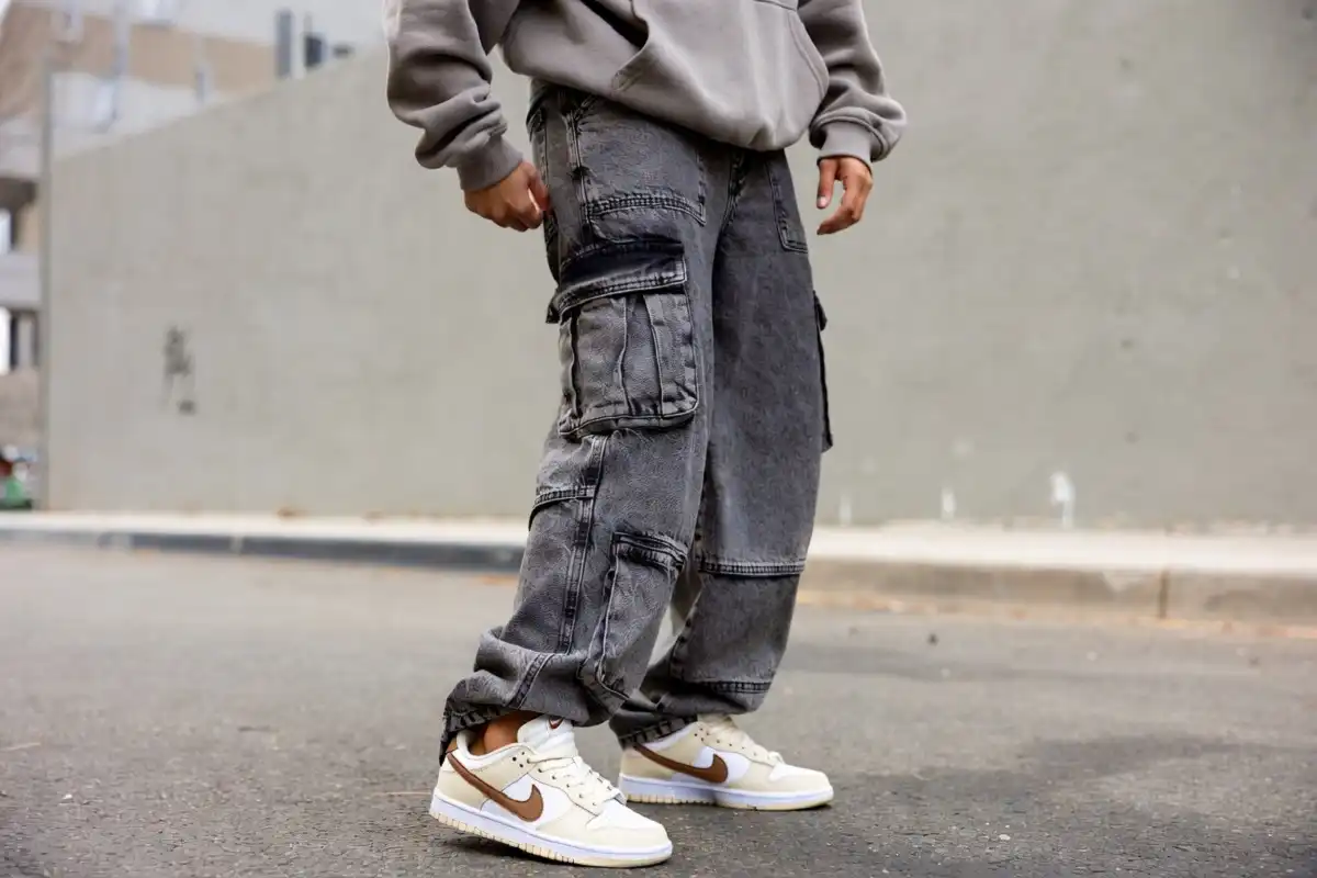 Person wearing Nike Dunk Low Next Nature with casual streetwear outfit