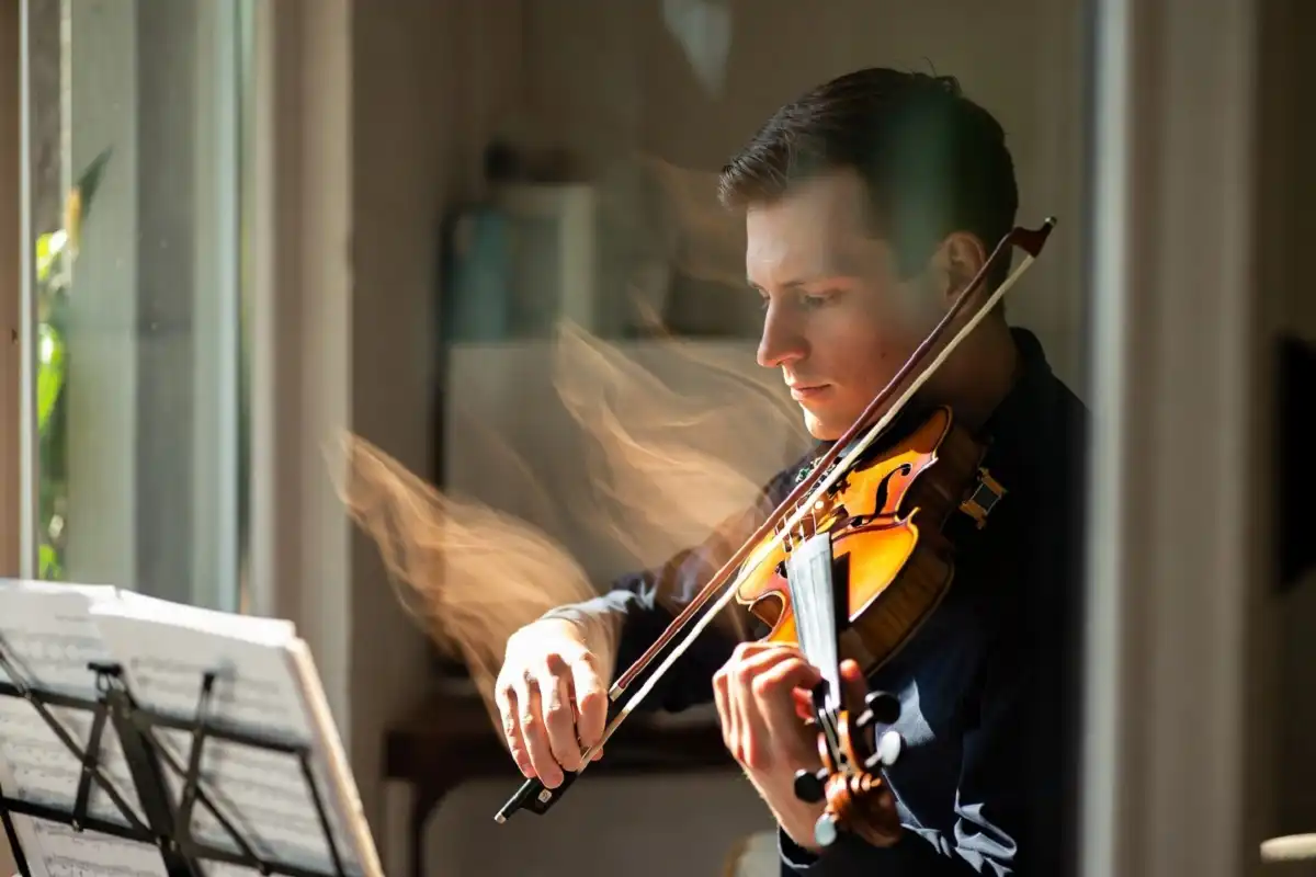 Violinist playing emotional music inspired by daylight