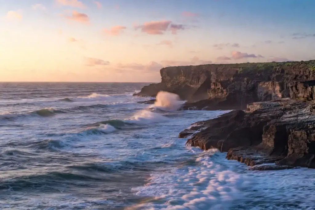 Coastal cliffs and ocean waves at sunset for nature photography 2026