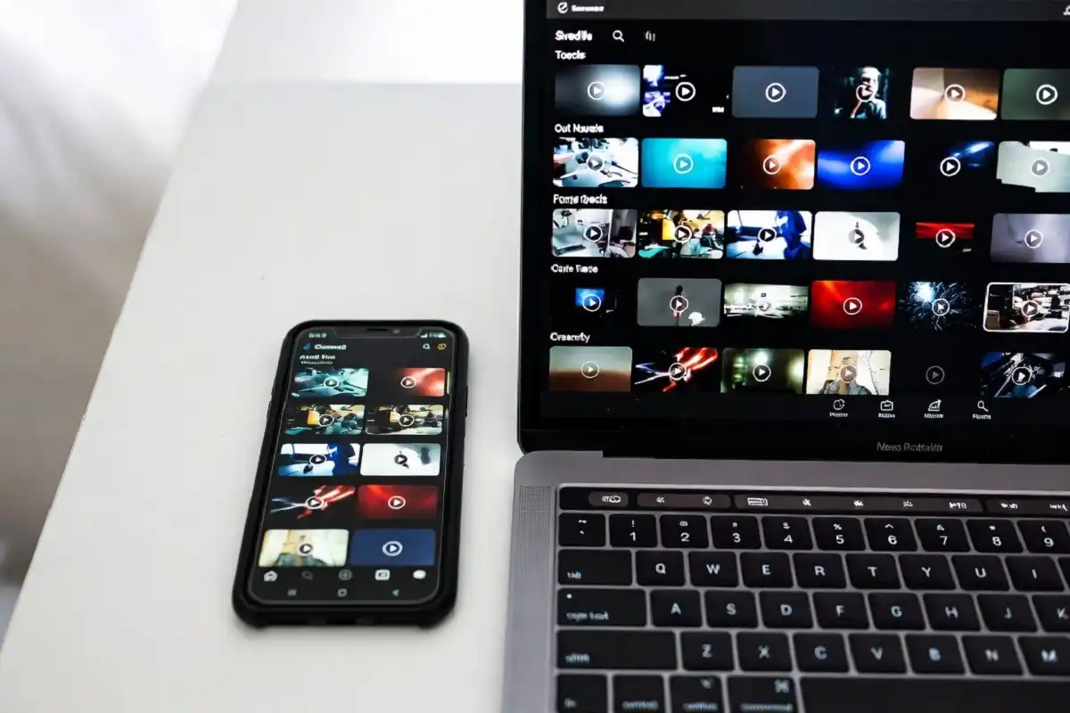Smartphone and laptop on a desk showing a save RedGif video gallery