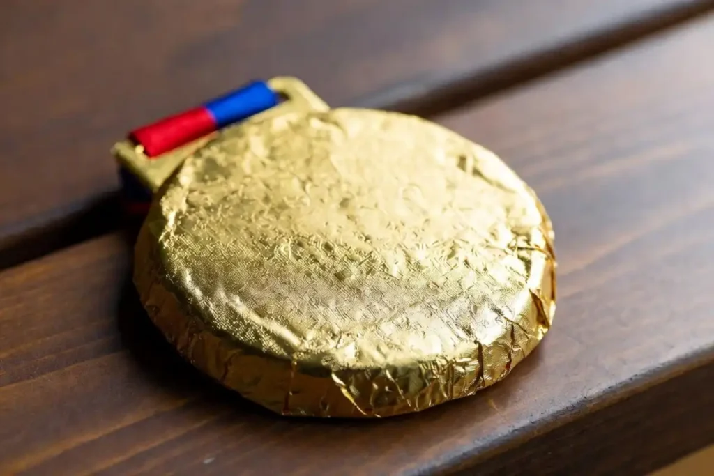 Close-up of a gold-foil chocolate medal celebrating national team pride