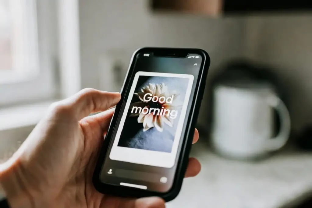 Smartphone displaying good morning wishes with flowers images sent to a friend